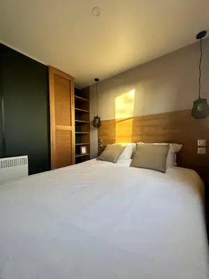 a bedroom with a large white bed with two pillows at Vakantiehuis 25 min Roermond Maasmechelen Maastricht in Kinrooi