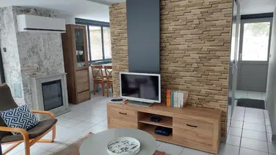 a living room with a tv on a wooden dresser at Opeteukske in Lanaken