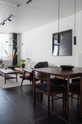 a living room with a table and a tv at ViaAmbioriX in Tongeren