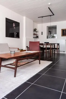 a living room with a table and a couch at ViaAmbioriX in Tongeren