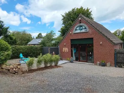 a brick building with a clock on top of it at Au nid douillet in Trooz