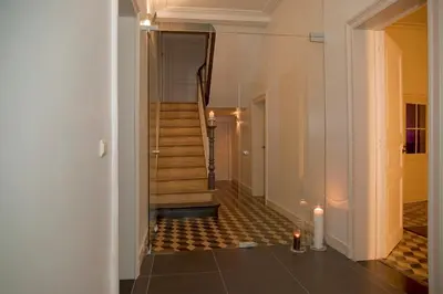 a hallway with stairs and candles in a building at A la Maison in Heks
