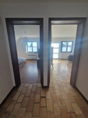 a room with two doors leading to a bedroom at Appartement à la campagne in Juprelle