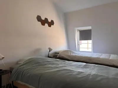 a bedroom with a bed and a window at Charming Apartment in Liège City Centre with Parking Included in Liège