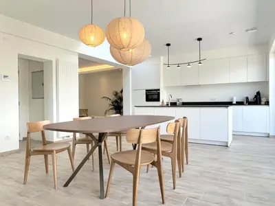a kitchen and dining room with a table and chairs at Hestia in Oudsbergen