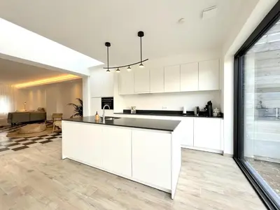 a kitchen with white cabinets and a counter top at Hestia in Oudsbergen