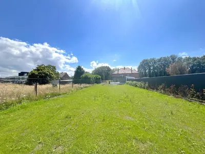 a field of green grass with a fence at Hestia in Oudsbergen