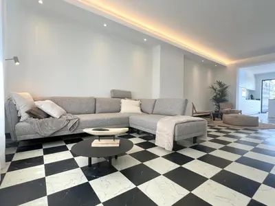 a living room with a couch and a checkered floor at Hestia in Oudsbergen