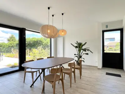 a dining room with a table and chairs at Hestia in Oudsbergen