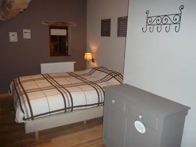 a small bedroom with a bed and a dresser at Gite des Comagnes in Limbourg