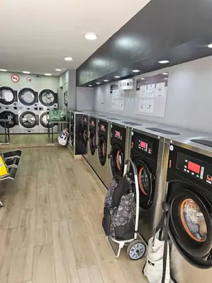 a laundry room with multiple washing machines in it at Logements Liège un in Liège