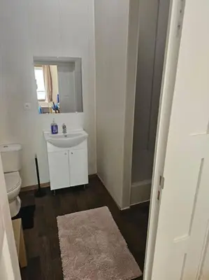 a bathroom with a white toilet and a sink at Logements Liège un in Liège