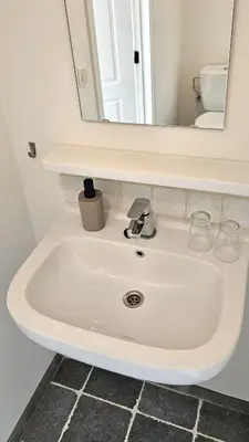 a white sink in a bathroom with a mirror at Vakantiehuis Pippa in Peer