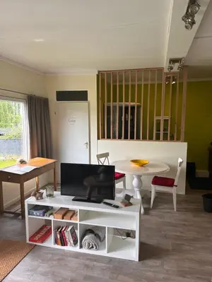 a living room with a white coffee table and a table at B&B Bombon in Herk-de-Stad