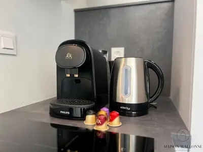 a coffeemaker and a coffee maker on a counter at Le studio des Guillemins - Boverie, Gare in Liège
