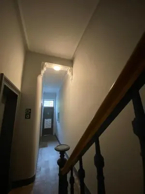 a hallway with a staircase with a stool in it at Sweet Home in Liège