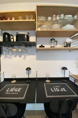 a kitchen with a table with glasses on it at Sweet Home in Liège