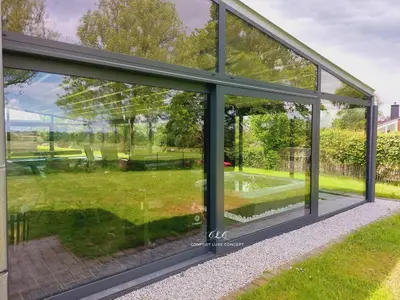 a glass house with a view of a garden at Villa VIP in Welkenraedt