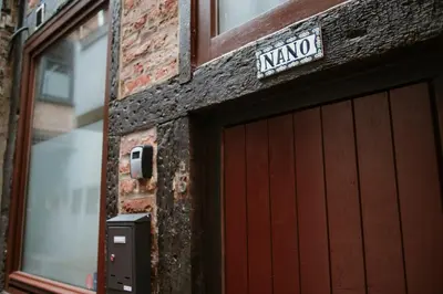 a garage door of a building with a sign on it at La Nano Maison de Liège in Liège