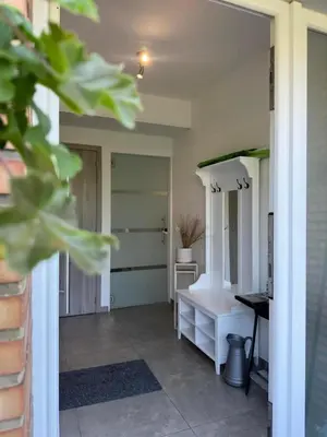a hallway with a room with a desk and a table at Comme chez vous in Soumagne