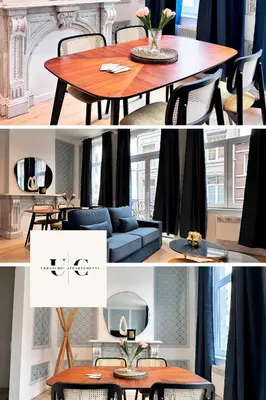 a living room with a table and a blue couch at Urbanchic Adalbert 1A in Liège