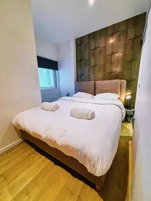 a bedroom with a large bed with two pillows on it at Urbanchic Adalbert 1A in Liège