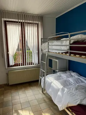a bedroom with a bunk bed and a window at Casa Fratello Bolderberg in Heusden - Zolder