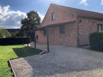 a large brick building with a covered driveway at Casa Fratello Bolderberg in Heusden - Zolder