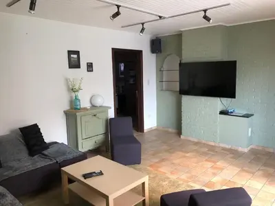 a living room with a couch and a tv at Casa Fratello Bolderberg in Heusden - Zolder