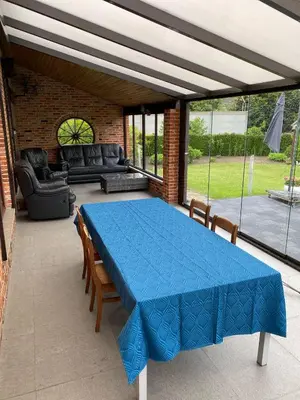 a patio with a blue table and chairs at Casa Fratello Bolderberg in Heusden - Zolder