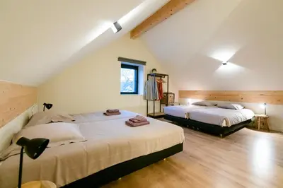 two beds in a room with a attic at Vakantiehuis Remersdaal in Voeren