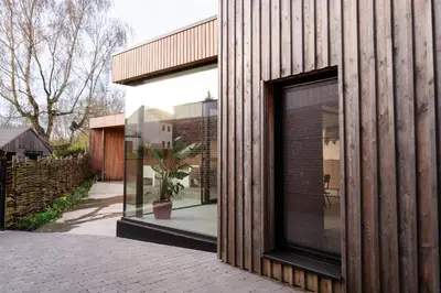 a house with a glass door on the side of it at Vakantiehuis Remersdaal in Voeren