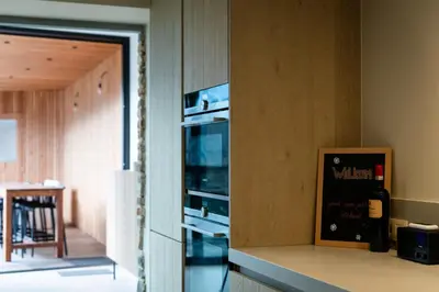 a kitchen with a counter with an oven in a wall at Vakantiehuis Remersdaal in Voeren