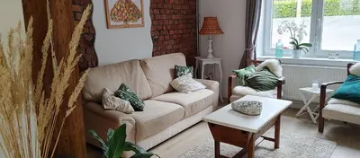 a living room with a couch and a table at Au petit 31 in Pepinster
