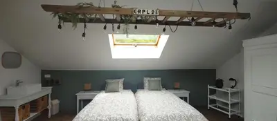 a bedroom with two beds and a window at Au petit 31 in Pepinster