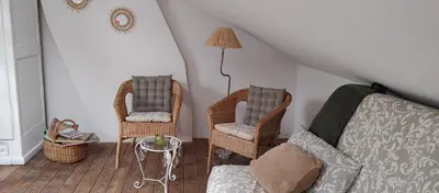 a living room with two chairs and a couch at Au petit 31 in Pepinster