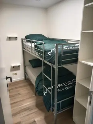 a room with two bunk beds with green sheets at Lindehoeve in Heusden - Zolder