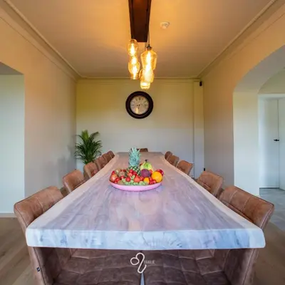 a table with a bowl of fruit on it at La Maison de Rose in Riemst