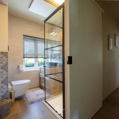 a bathroom with a toilet and a window at La Maison de Rose in Riemst