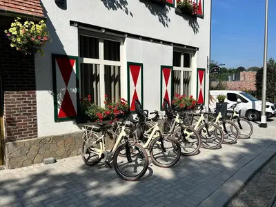 a row of bikes parked outside of a building at La Maison de Rose in Riemst