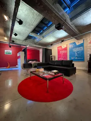 a living room with a red rug and a table at Sleep You Soon - Loft & parking in Liège