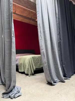 a bed with grey curtains in a room at Sleep You Soon - Loft & parking in Liège