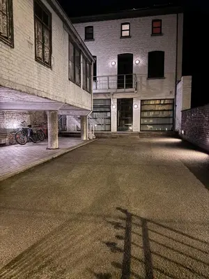 an empty parking lot in front of a building at Sleep You Soon - Loft & parking in Liège