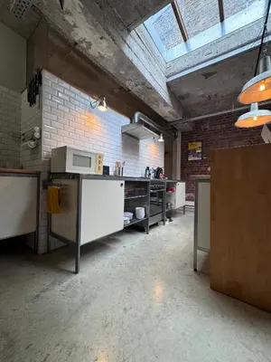a large room with a kitchen with a ceiling at Sleep You Soon - Loft & parking in Liège