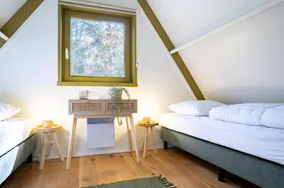 two beds in a room with a window at Boshuisje Rekem - Olive in Lanaken