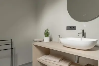 a bathroom with a white sink and a mirror at Vakantie aan de Maas - Vakantiewoning Neerhof in Kinrooi