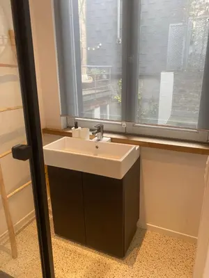 a bathroom with a sink and a window at En NEUVICE 27 in Liège