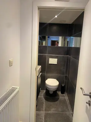 a bathroom with a white toilet in a room at En NEUVICE 27 in Liège