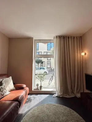 a living room with a couch and a window at Residentie Papillon in Hasselt