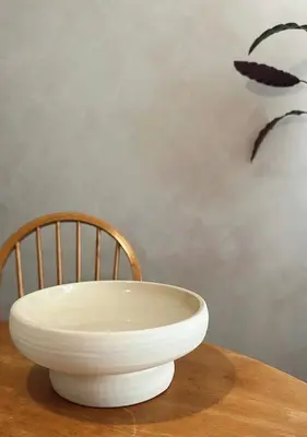 a white bowl sitting on top of a wooden table at Residentie Papillon in Hasselt